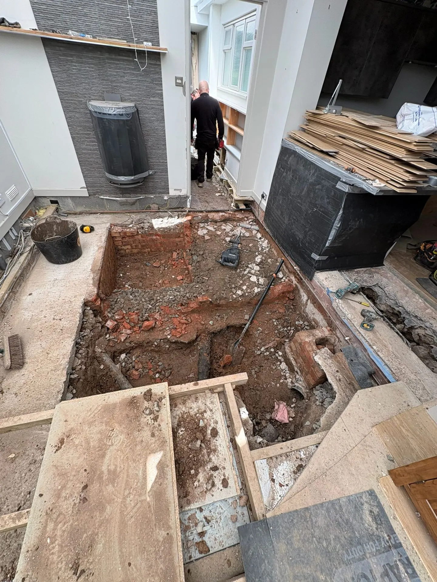 Indoor floor excavation exposing old drainage
