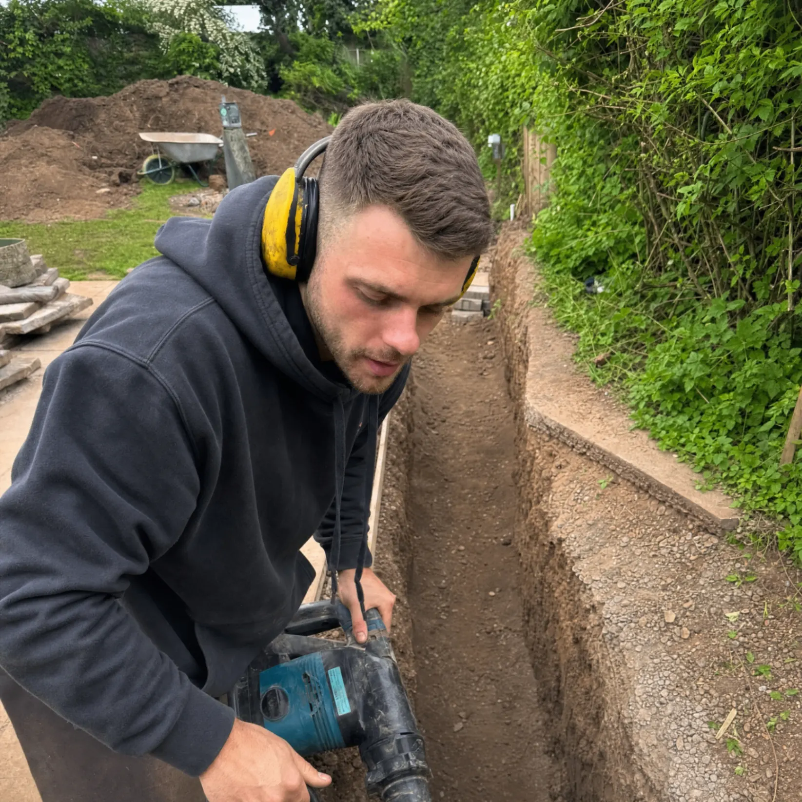 Mini-digger working on a new drainage trench