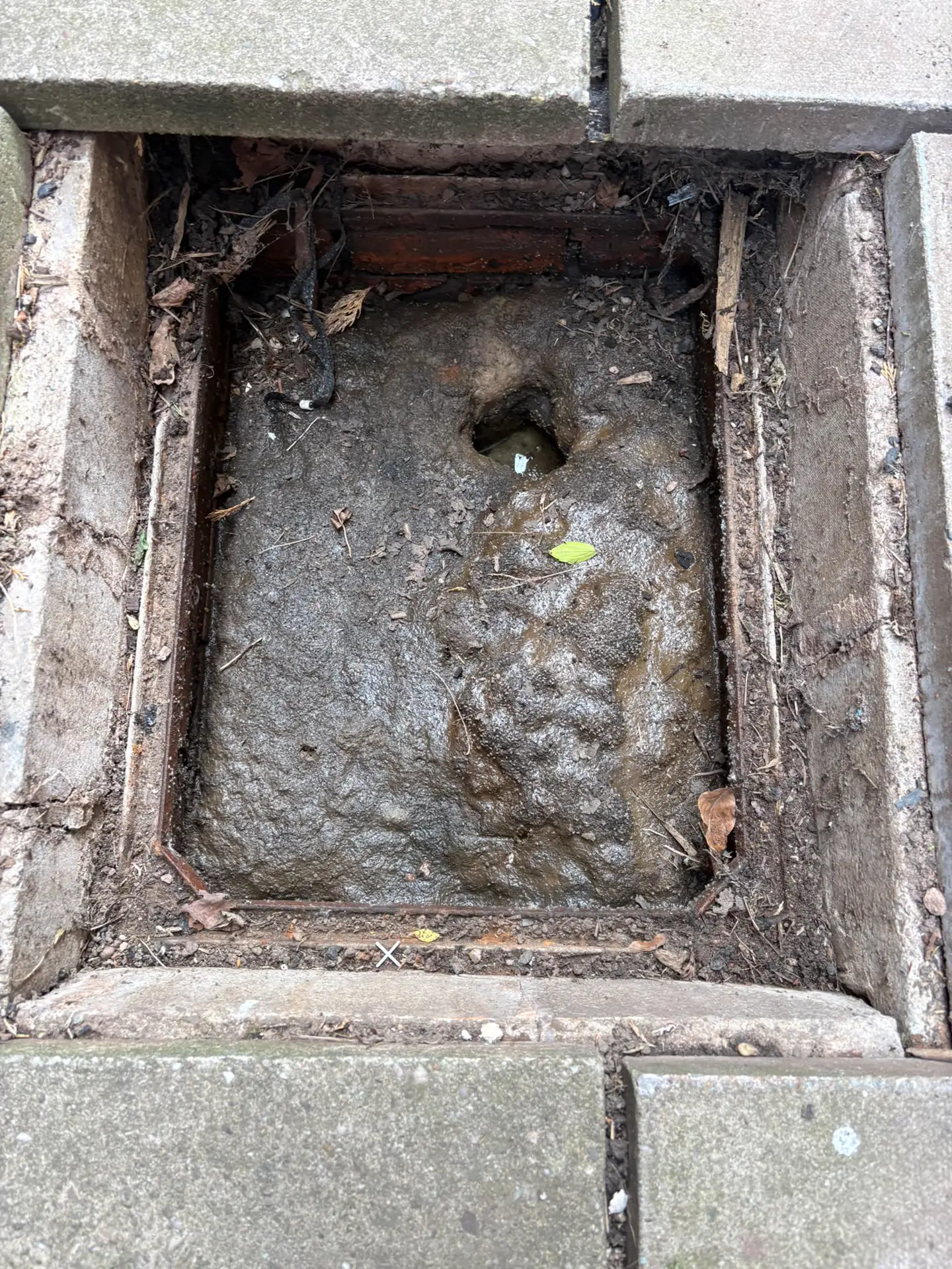 Block-paved gully packed solid with congealed fat and silt