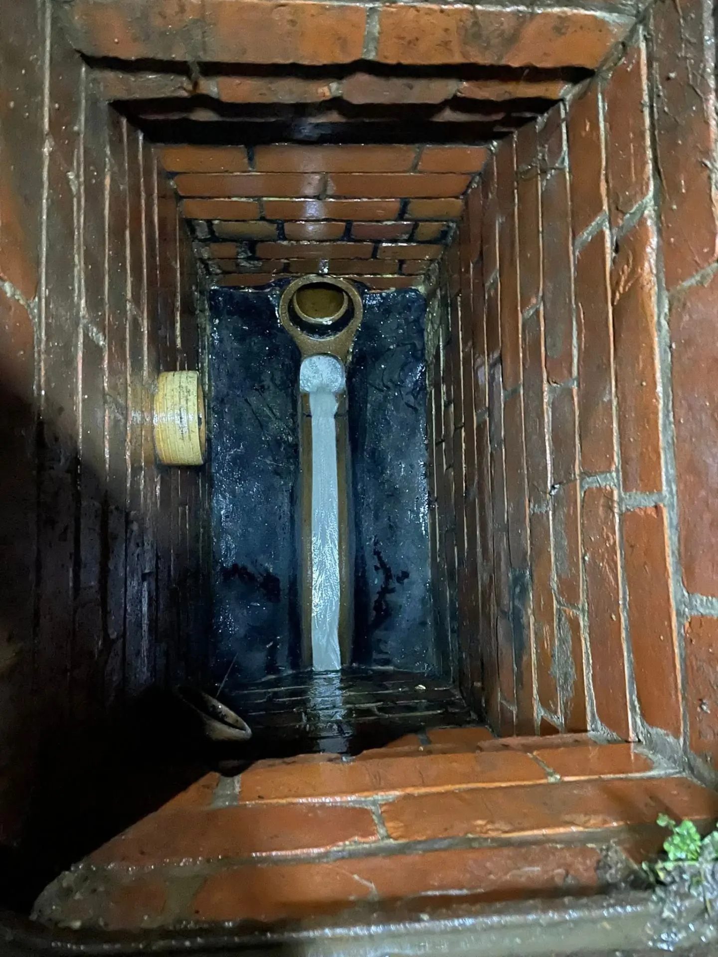 Engineer unblocking a manhole chamber